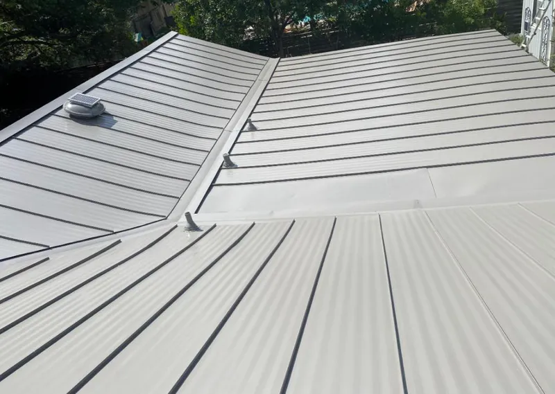 Solar attic fan installed on a metal roof for Roof Ventilation in Ross